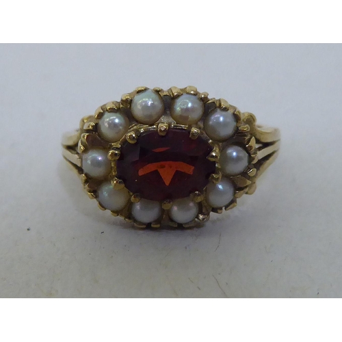 290 - A 9ct gold garnet and seed pearl cluster ring