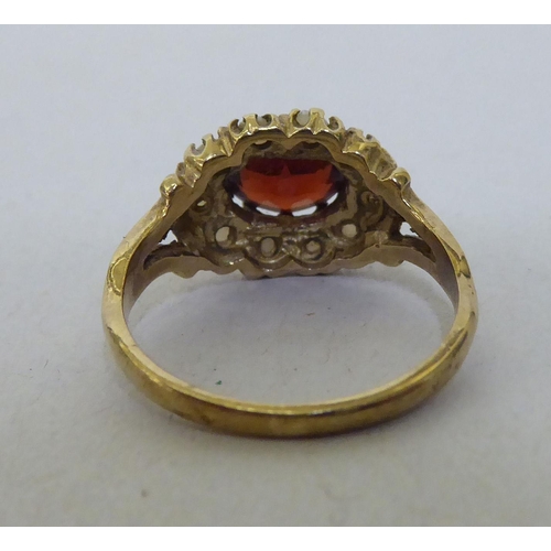 290 - A 9ct gold garnet and seed pearl cluster ring