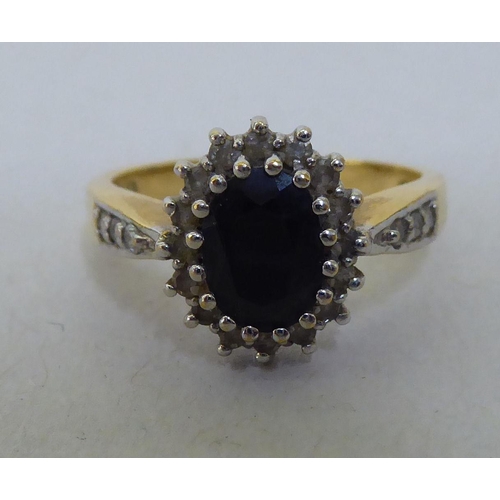 306 - An 18ct gold diamond and sapphire cluster ring