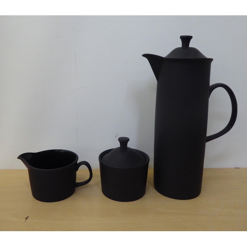 307 - A Wedgwood black basalt coffee set, comprising six cans and saucers, coffee pot, sugar pot and cream... 