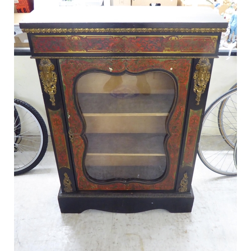 31 - A late Victorian French ebonised, boulleworked style pier cabinet with a glazed door, enclosing two ... 