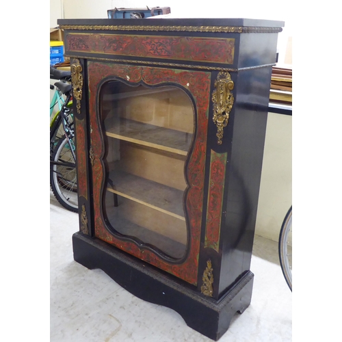 31 - A late Victorian French ebonised, boulleworked style pier cabinet with a glazed door, enclosing two ... 