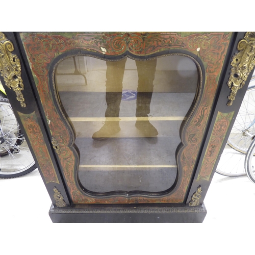 31 - A late Victorian French ebonised, boulleworked style pier cabinet with a glazed door, enclosing two ... 