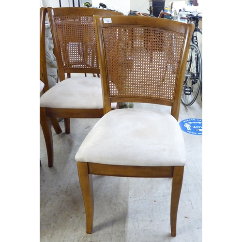 34 - A set of six modern beech framed dining chairs with caned backs and fabric upholstered seats, raised... 