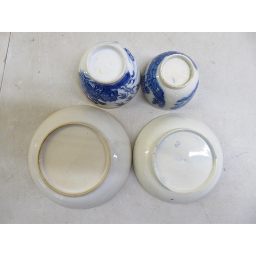 35 - Two 19thC porcelain tea bowls and saucers, decorated in blue and white Oriental taste