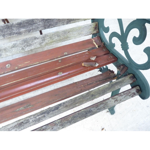 41 - A weathered teak bench, on painted cast metal ends  49