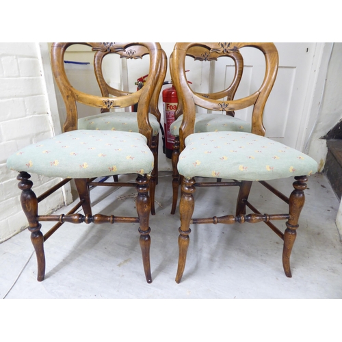 57 - A set of four early 20thC stained beech framed balloon back and later fabric upholstered chairs, rai... 