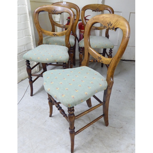 57 - A set of four early 20thC stained beech framed balloon back and later fabric upholstered chairs, rai... 