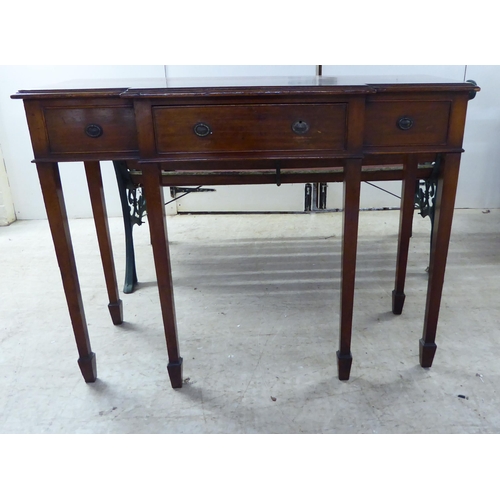 61 - An early 20thC Georgian style mahogany breakfront sideboard with a central drawer, flanked by two fa... 