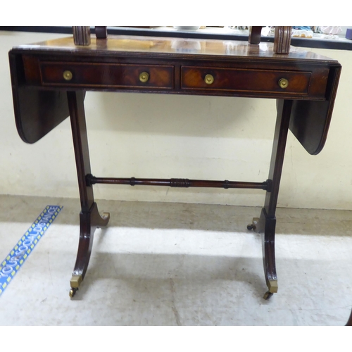 64 - Four items of small furniture: to include a reproduction of a George III sofa table  29