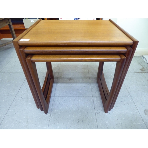 83 - A nesting set of three G-Plan teak occasional tables, raised on splayed legs  largest 19