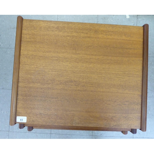 83 - A nesting set of three G-Plan teak occasional tables, raised on splayed legs  largest 19