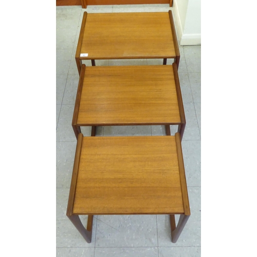 83 - A nesting set of three G-Plan teak occasional tables, raised on splayed legs  largest 19