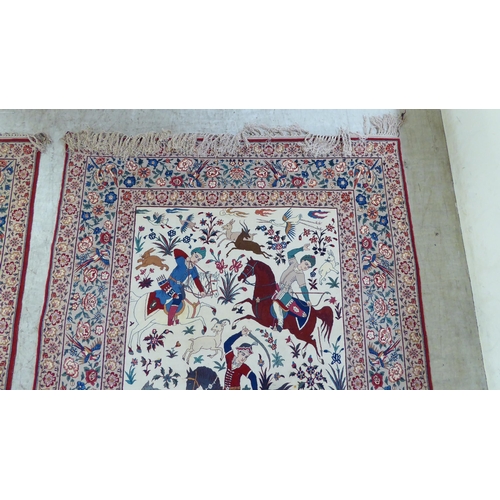 94 - A pair of Persian part woven silk pictorial rugs, depicting figures on horseback, on a hunt  59... 