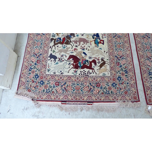 94 - A pair of Persian part woven silk pictorial rugs, depicting figures on horseback, on a hunt  59... 