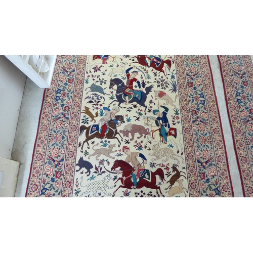 94 - A pair of Persian part woven silk pictorial rugs, depicting figures on horseback, on a hunt  59... 