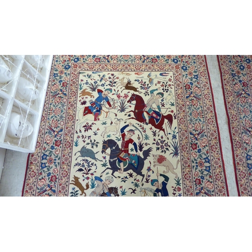 94 - A pair of Persian part woven silk pictorial rugs, depicting figures on horseback, on a hunt  59... 