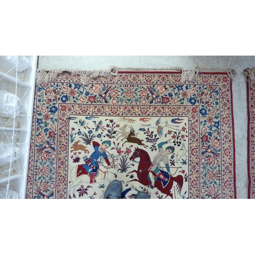 94 - A pair of Persian part woven silk pictorial rugs, depicting figures on horseback, on a hunt  59... 