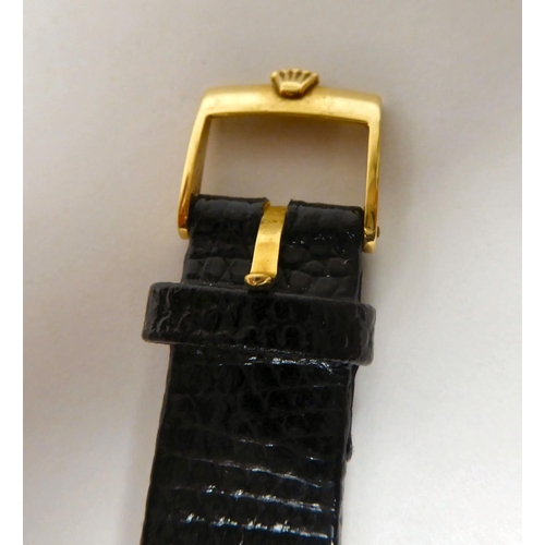 104 - A Rolex Cellini 18ct gold cased wristwatch, faced by a baton dial, on a brown hide strap