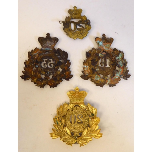 110 - Four British military cap badges/helmet plates: to include a 20th East Devon Regiment of Foot(Please... 