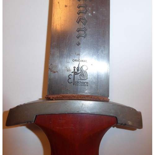 112 - A German student's dagger with a stained brown handgrip and applied swastika emblem, the 8.5