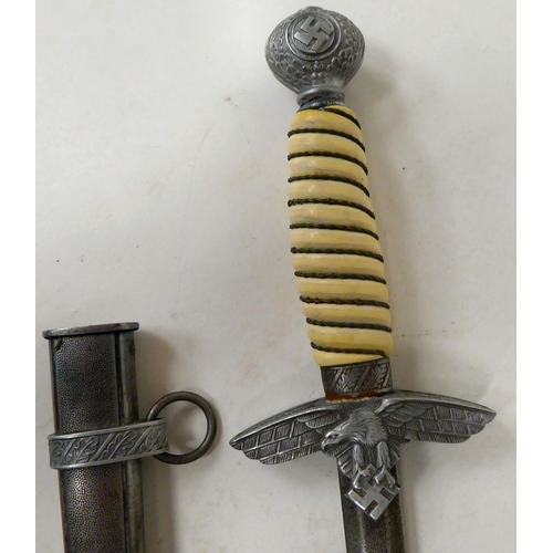 119 - A German Luftwaffe dagger, the pommel with oakleaf and swastika emblems, the wire bound celluloid ha... 