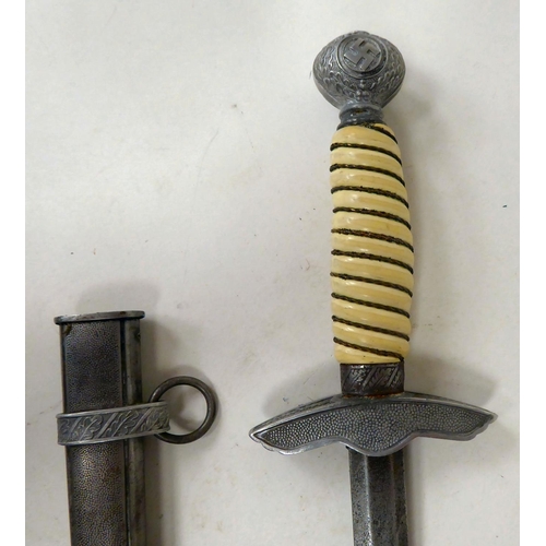 119 - A German Luftwaffe dagger, the pommel with oakleaf and swastika emblems, the wire bound celluloid ha... 