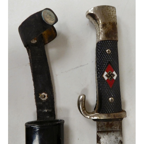 129 - A German Hitler Youth knife with an applied swastika emblem, on a textured two-part handgrip, the 5.... 