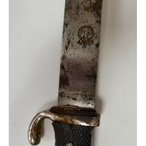 129 - A German Hitler Youth knife with an applied swastika emblem, on a textured two-part handgrip, the 5.... 