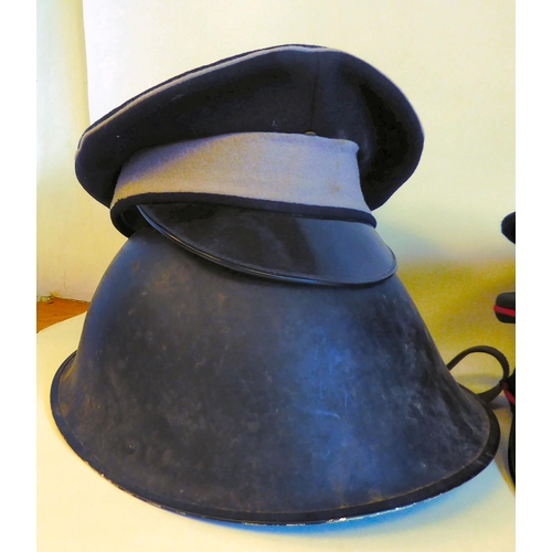 130 - Four various military and related peaked caps, a beret and a painted steel helmet(Please Note: this ... 