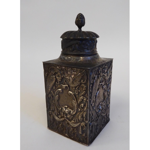 133 - A late Victorian silver tea caddy of shouldered, rectangular box design, the cover incorporating a b... 