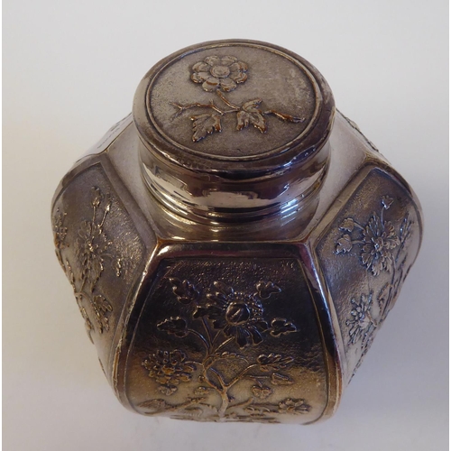 135 - A late 19th/early 20thC Christoffel white metal tea caddy of hexagonal form with a cover, decorated ... 