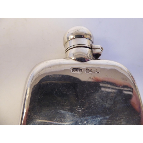 137 - A silver cushion moulded hip flask with a rotating, hinged cap; and a lozenge shape vesta case with ... 