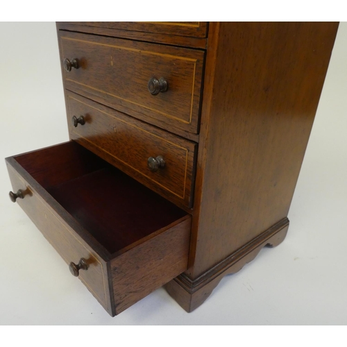 14 - A string inlaid mahogany miniature, five drawer dressing chest, in the manner of an apprentice piece... 