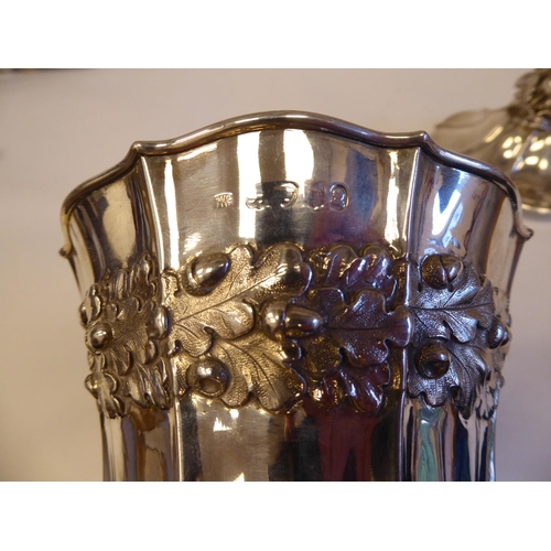 145 - A Georgian silver, twin handled, pedestal cup and cover, decorated with acorns and oak leaves, flora... 