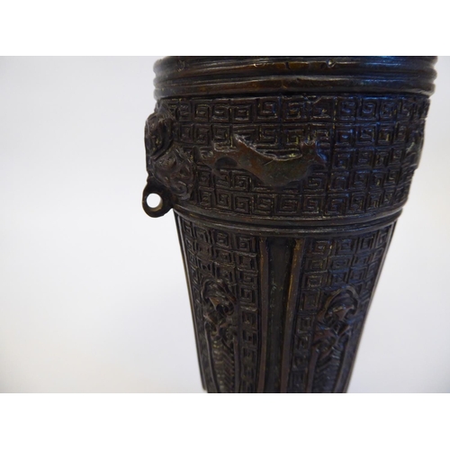 148 - A Chinese cast bronze vase of shouldered, tapered form with a narrow neck and flared rim, decorated ... 