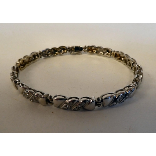 15 - An 18ct white gold, fancy link bracelet, set with diamonds; and an 18ct white gold ring, similarly s... 