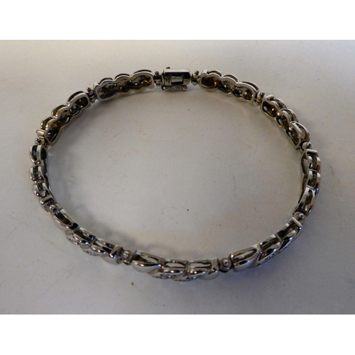 15 - An 18ct white gold, fancy link bracelet, set with diamonds; and an 18ct white gold ring, similarly s... 