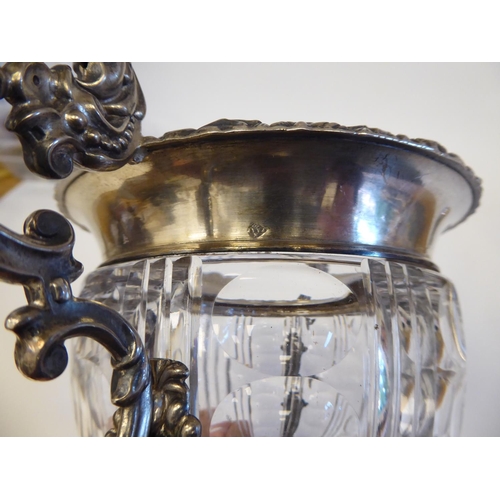 155 - A Continental white metal ice bucket with a cut glass bowl, set in a twin handled frame with a lid, ... 