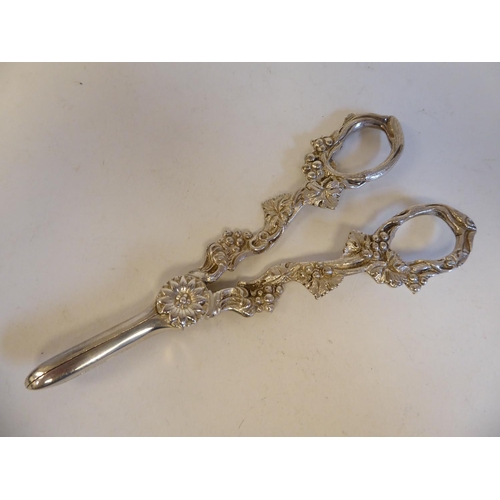 160 - A pair of 19thC style silver grape scissors; and a silver cocktail spoon, the terminal cast with a s... 