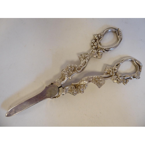 160 - A pair of 19thC style silver grape scissors; and a silver cocktail spoon, the terminal cast with a s... 