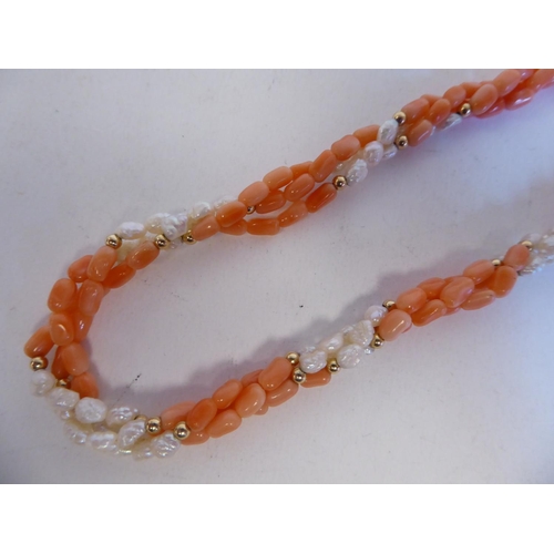 162 - A coral and river pearl triple strand necklace with yellow metal beads, on a bayonette clasp  s... 