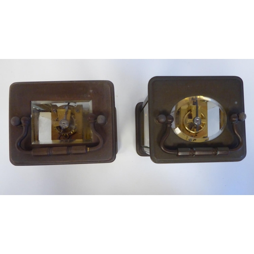 172 - Two similar brass cased carriage timepieces with bevelled glass panels and folding top handles; the ... 