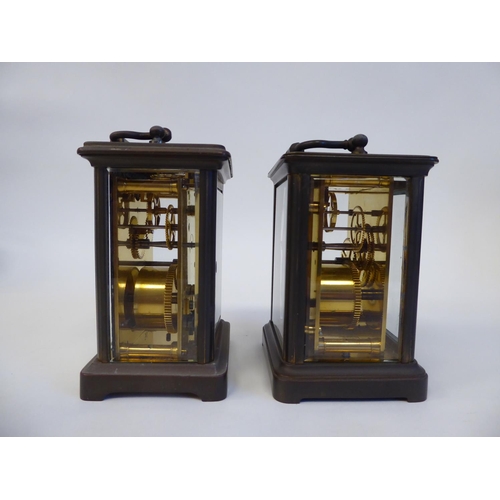 172 - Two similar brass cased carriage timepieces with bevelled glass panels and folding top handles; the ... 