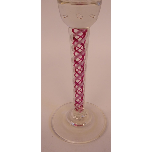 173 - An 18thC style wine glass, the flared bowl with fruiting vine engraved ornament, the tapered white a... 