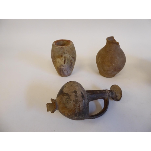 174 - Ancient earthenware pottery and fragments: to include jugs and Shabti type figures  largest 6