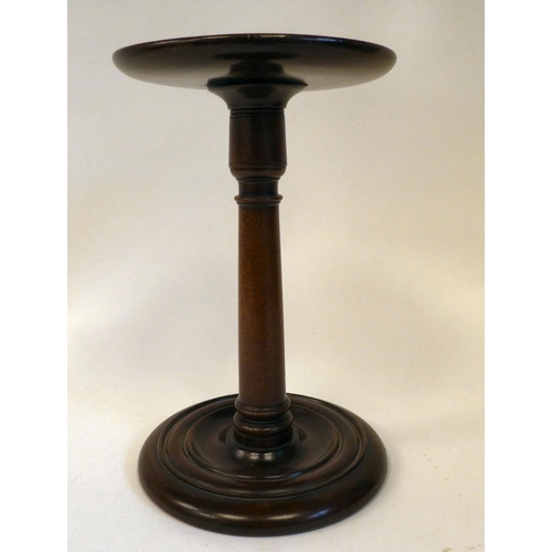 18 - A 19thC mahogany candlestand with a height adjustable plate, on a plain column and turned saucer bas... 