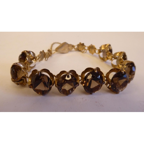 191 - Three variously set yellow metal, smokey quartz and citrine bracelets