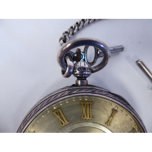 205 - A silver cased pocket watch, faced by a floral engraved and gilded Roman dial, on a silver curb link... 