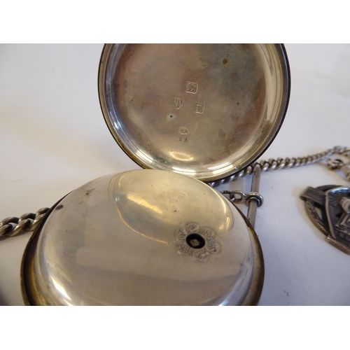 205 - A silver cased pocket watch, faced by a floral engraved and gilded Roman dial, on a silver curb link... 